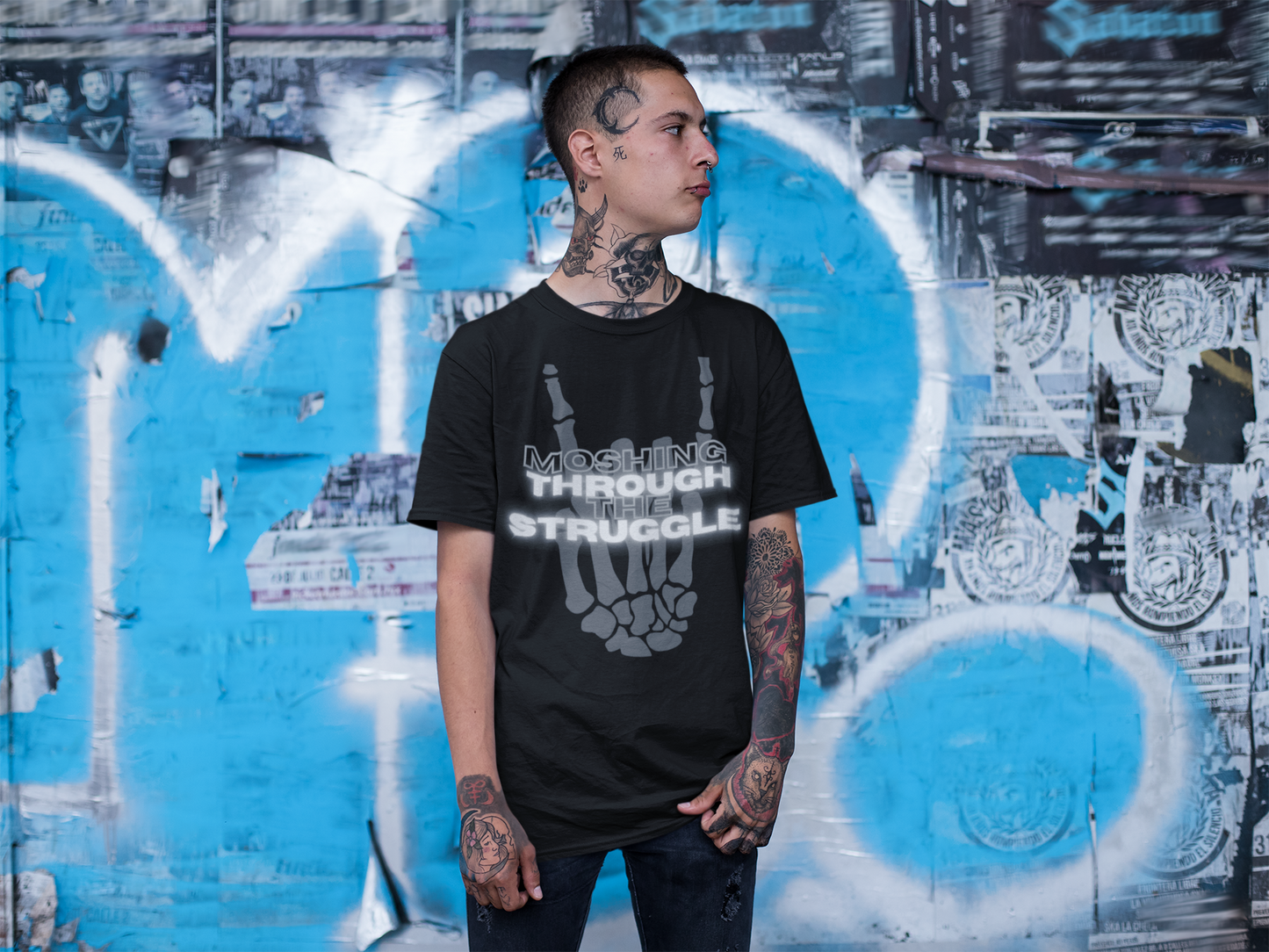 tattooed male model staring to the left, donning the black, short sleeved Moshing Through the Struggle Shirt